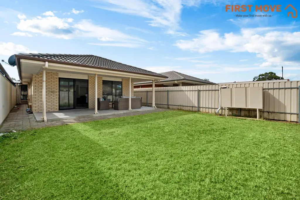5A Rowe Avenue, Northfield, SA 5085 Spacious backyard with green lawn.